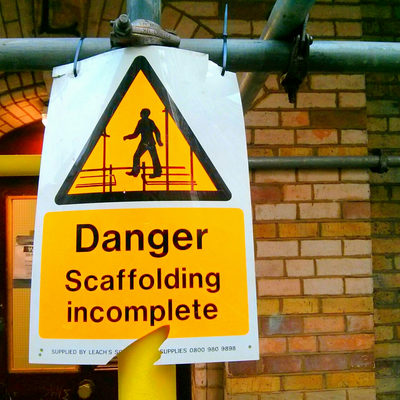 A couple of scaffolding signs